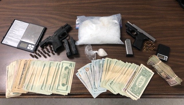 Agents seized approximately one kilogram of methamphetamine, two firearms, and an undisclosed amount of U.S. currency.